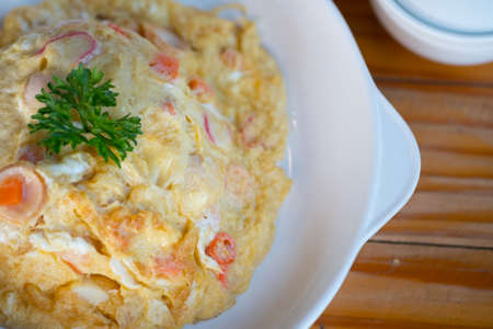 Omelet with steamed rice on top, easy to cook and easy to eat in Thailand style.