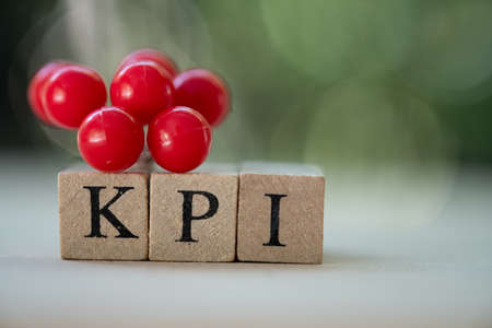 Small wooden cube block with alphabets building the word KPI.  Key Performance Indicator concept