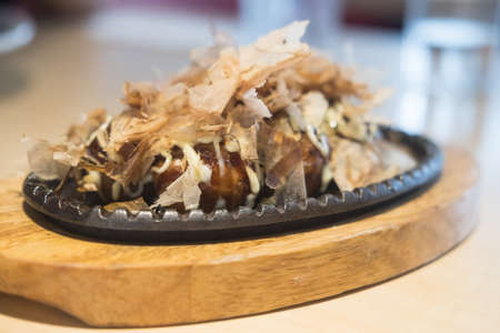 Japanese snack food Takoyaki. Takoyaki is a ball-shaped Japanese snack