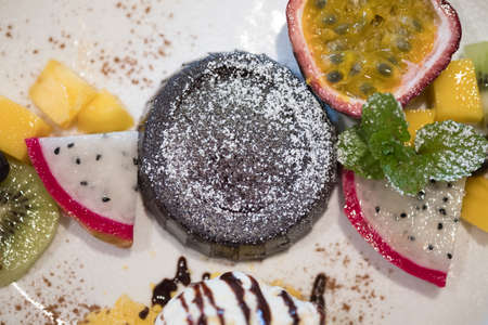 Chocolate fondant lava cake with fruit, close upの写真素材