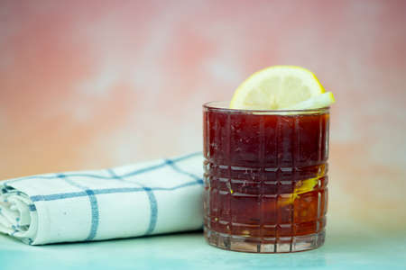 Glass of delicious blueberry juice with lemon and slice lemon decoration on topの写真素材