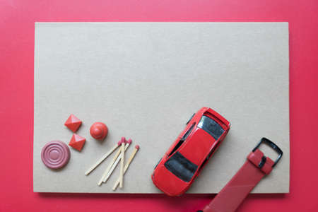 Top view of Thai chess, toy car, smart watch and matchstick put on brown notebook. Concept of...
