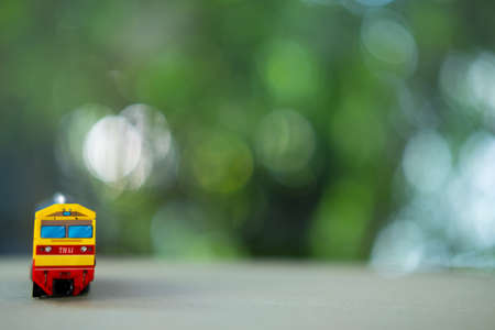 Front view of Thai miniature old yellow diesel train. Train connect the city to countryside in...