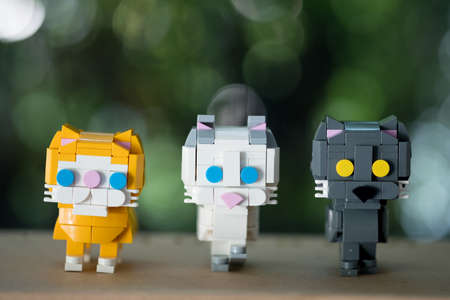Plastic figure toy cat, three color with nature backgroundの写真素材
