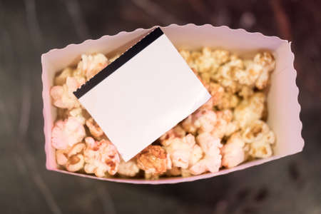 Movie tickets with popcorn snack. Home theatre movie or series night conceptの写真素材