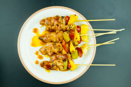 Grilling chicken bbq sauce bamboo skewers with tomatoes, pineapple and paprika peppersの写真素材