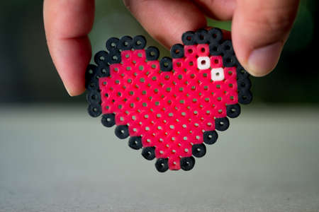 Hand holding plastic heart. Happy Valentine's day hearts. Valentine card with space for text