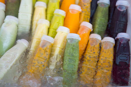 Fresh of fruit and herbal juice in plastic bottle in Thai marketの写真素材