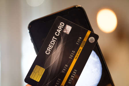 Credit card and smartphone. Online payment for purchases from online stores. Online shopping