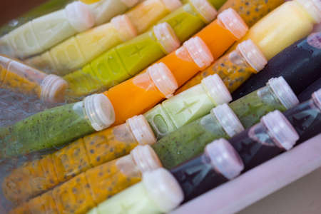 Fresh of fruit and herbal juice in plastic bottle in Thai marketの写真素材
