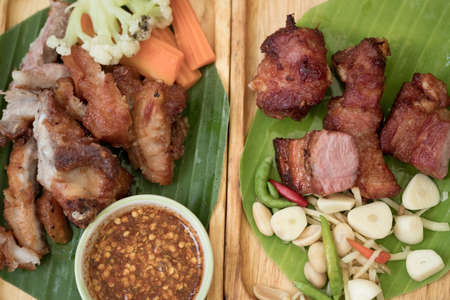 Fried pork rib, deep fried fried pork rib or fried pork served on banana leafの写真素材
