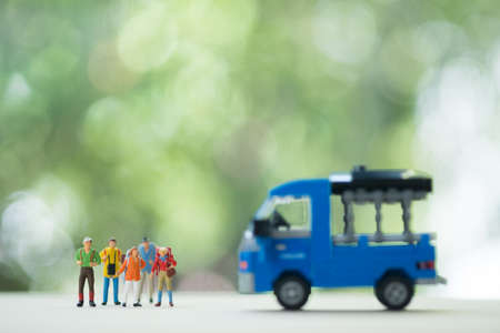 Miniature people : Travelers miniature with backpack hitchhiker for travelling. Begin great adventure in your lifeの写真素材