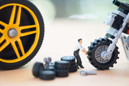 Miniature repairman : Motorcycle wheel repair. Modification of certain parts of a motorcycle when it is used for a certain period of time by an experienced technician. Motorcycle repairの写真素材