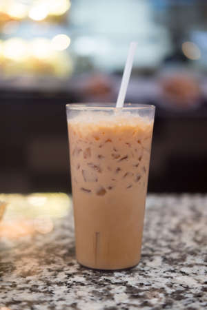 Iced milk tea or Thai milk tea in glass with strawの写真素材
