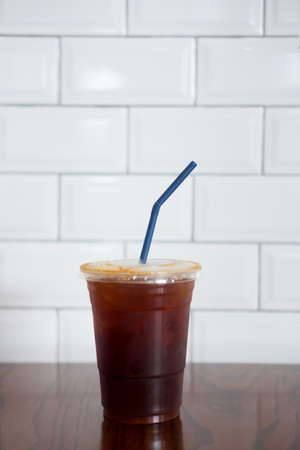 Ice black coffee on wood table. Cold summer drink