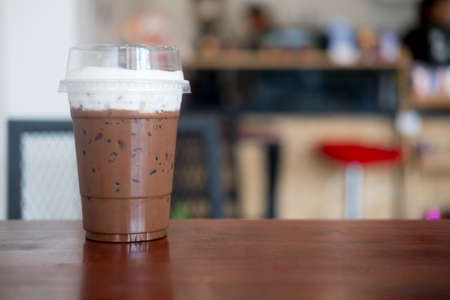 Glass of iced mocha with cream on top at coffee shopの写真素材