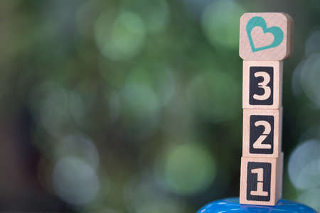 Wooden block of number and heart with nature background. Concept of time to loveの写真素材