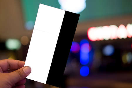 Hand holding three cinema paper tickets. Template design for advertising, movie entertainment showの写真素材