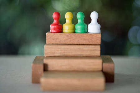 Chess pawn on a toy wooden ladder. Concept to symbolize achievement, growth and success.の写真素材