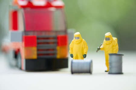 Miniature people : chemical team in hazmat suits and fire truck. Safety conceptの写真素材