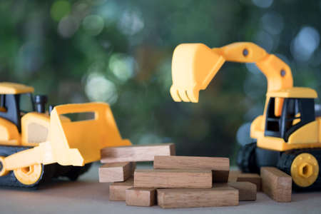 Diorama construction with yellow construction machinery models. Children's toys of construction machineryの写真素材