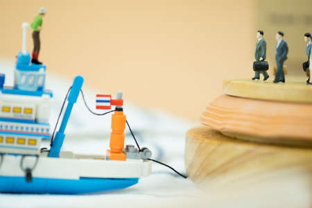 Miniature people: Passenger waiting generic Thai fishing ship. Travel in Thailand