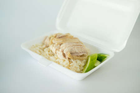 Hainanese chicken rice or steam chicken rice in foam box. Thai street food styleの写真素材