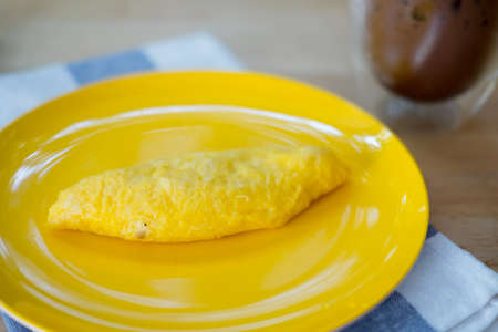 Omelette rolled on yellow dish in the morningの写真素材