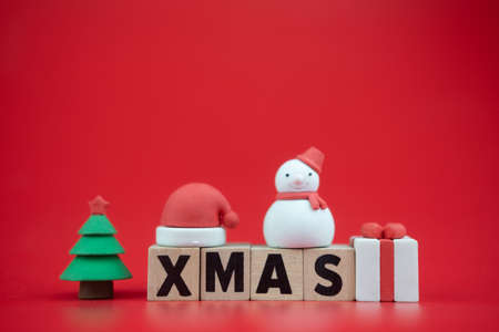 Wooden blocks of XMAS with Christmas ornament on red background. Christmas conceptの写真素材