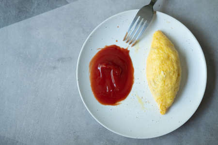 Egg omelet roll served with kitchen in white dishの写真素材