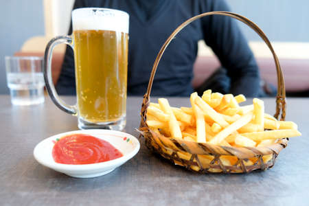 French fries served in basket and cold of beer in cold weather