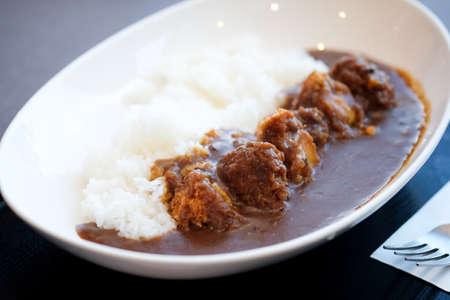 Curry rice with fried pork in white bowl. Japanese food