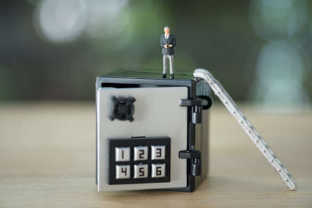 Business people stand on safe box. Concept of money protectionの写真素材