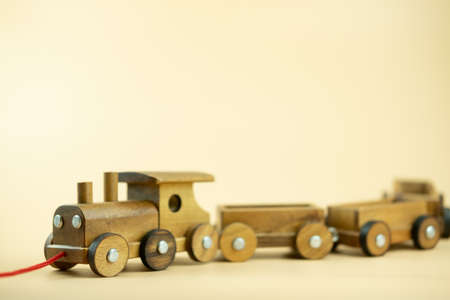 Wooden toy train on yellow background. Preschool and child play conceptの写真素材