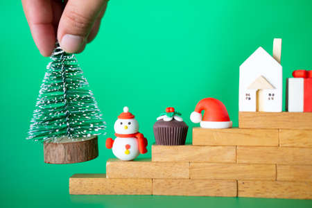 Hand put Miniature Christmas tree on Stair step wood block