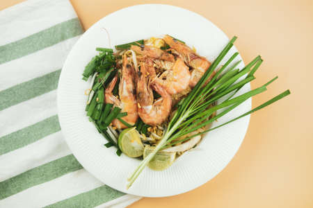 Close up a plate of Pad Thai or Thai style fried noodle topped with prawnsの写真素材