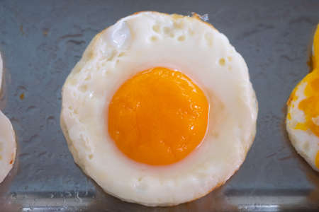 Closeup of fried eggs. A popular food by the hotel and restaurant in Thailand. Easy to find and...