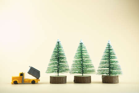 Yellow pickup truck delivery of Christmas tree. Happy new year and merry christmasの写真素材