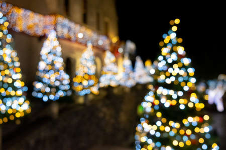 Blur lighting of Christmas tree abstract blur background. Out of focus holiday background with christmas treeの写真素材