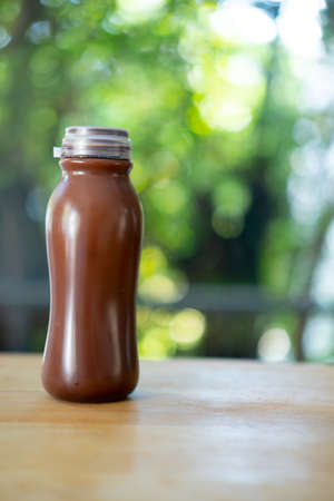 Iced chocolate in plastic bottle on wood tableの写真素材