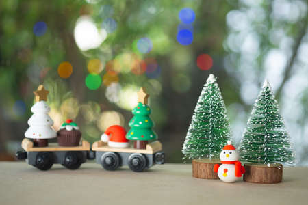 Festive wooden train and Christmas toy with on nature background. Christmas and New Year toy.の写真素材