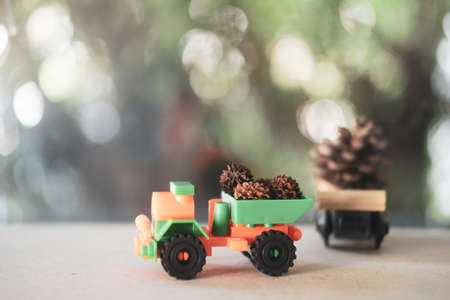 The truck carries a pine cone on wood table. Preparation for the holidayの写真素材
