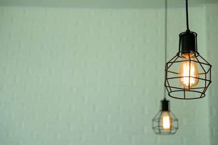 Light bulbs glowing. Warm light. Coffee shop interior.の写真素材