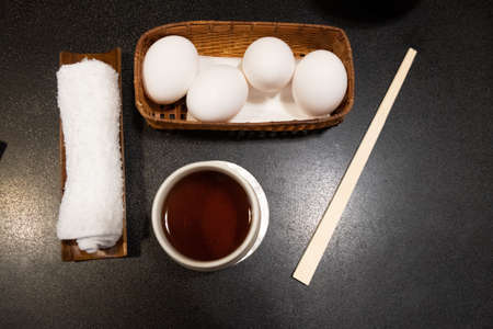 Hot tea and cold towels with duck egg for waiting food in Shabu restaurant