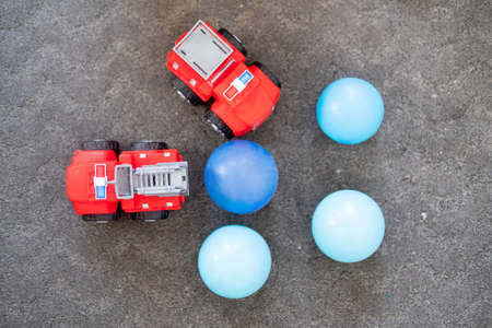 Red fire truck and blue plastic ball. Concept of childhoodの写真素材