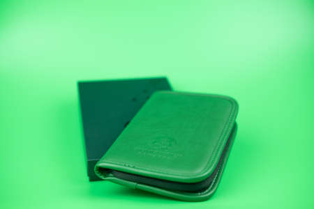 Bangkok, Thailand - January 1, 2020 : Green passport bag form Starbucks coffee shop a gift for rewards card Gold Level on green backgroundのeditorial素材