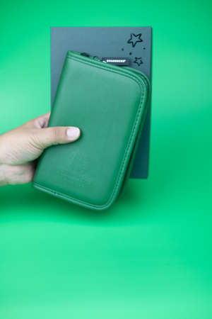 Bangkok, Thailand - January 1, 2020 : Green passport bag form Starbucks coffee shop a gift for rewards card Gold Level on green backgroundのeditorial素材