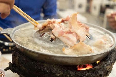 Thai barbecue buffet grill pork on hot pan. Moo-Kra-Ta in Thai wordの写真素材