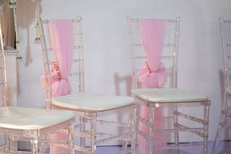 Banquet wedding chairs setting on evening reception awaiting guestsの写真素材