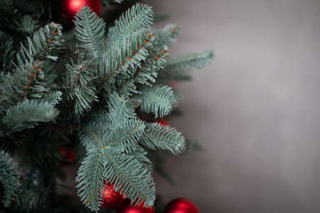 Red ball hanging from Christmas tree.  Close up
